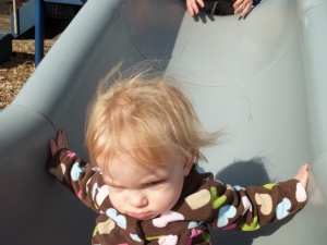 Charlie's first time going down a slide by herself. Despite the look on her face, she asked to do it " 'gain!". 